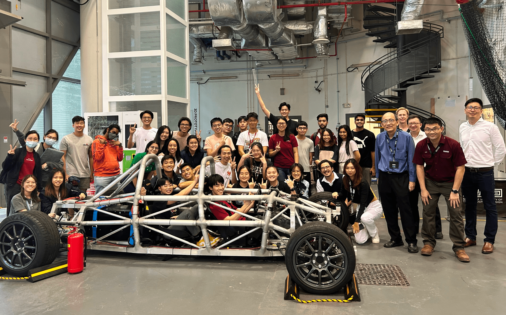 DAI students with car prototype