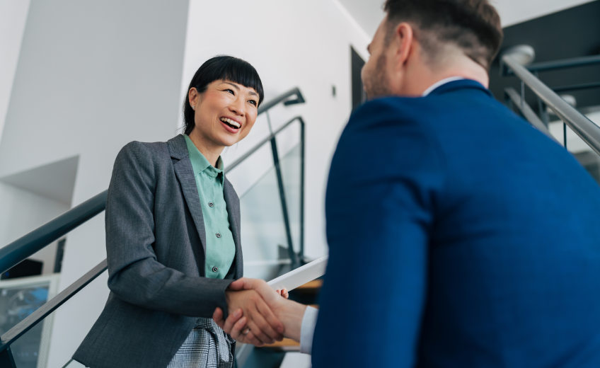 Woman and man shaking hands