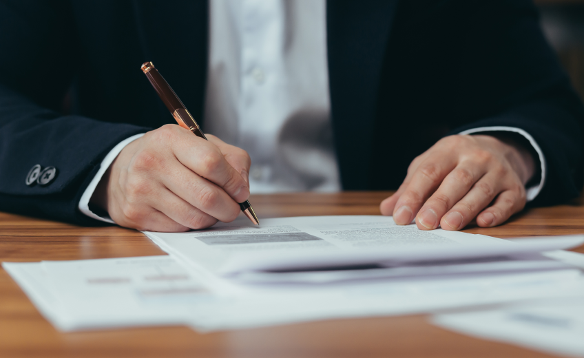 Businessman writing on paper