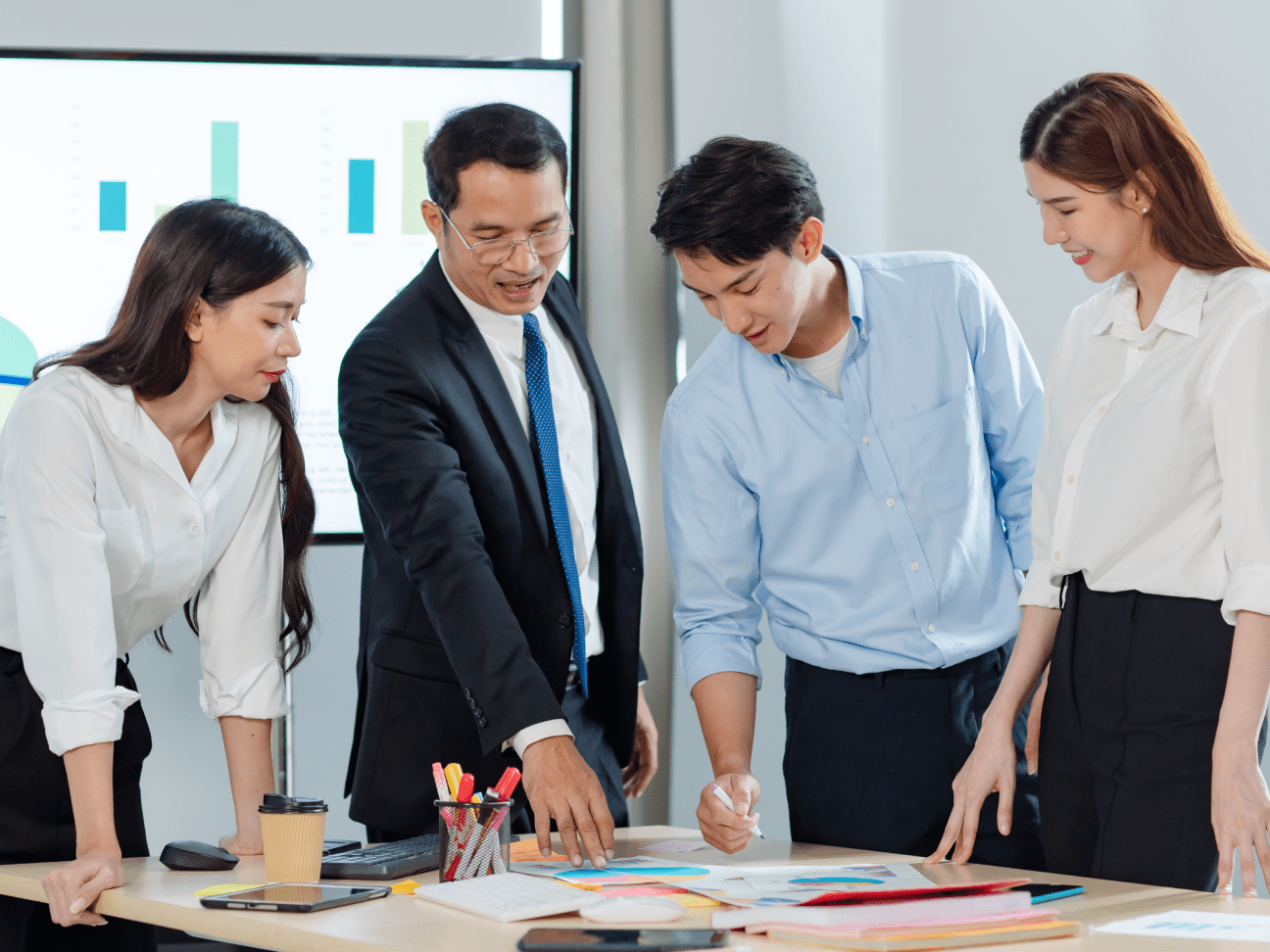 People standing around a table discussing and planning